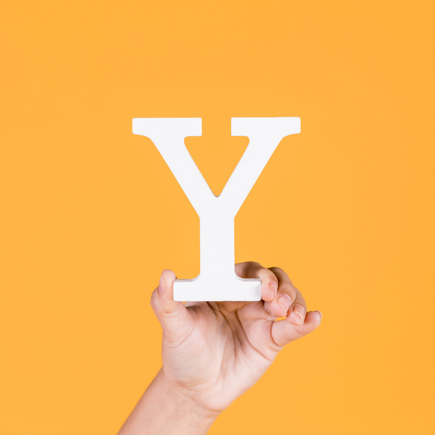 close up hand holding up alphabet y background